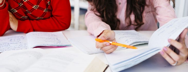 hand-pointing-at-notes-in-notebook