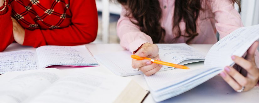 hand-pointing-at-notes-in-notebook